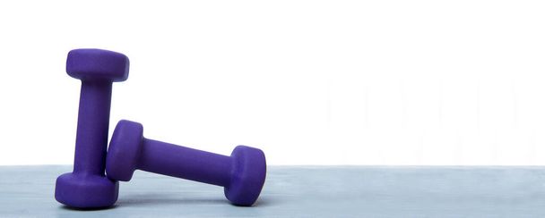 Small blue dumbbells on grey wooden floor. Online workout concept - Photo, Image