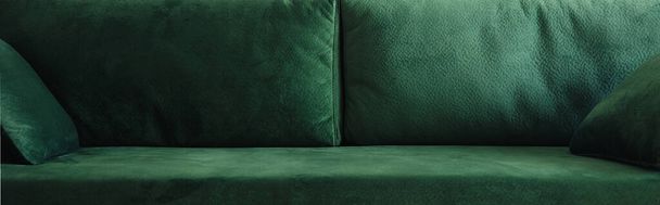 close up view of modern green sofa with pillows, panoramic shot - 写真・画像
