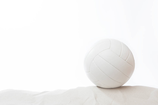  White beach volleyball in the sand on white background - Foto, Bild