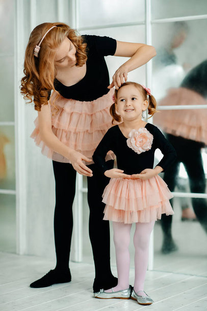 Children's choreography. Mom spends free time with her daughter. Little girl and sport. - Foto, imagen