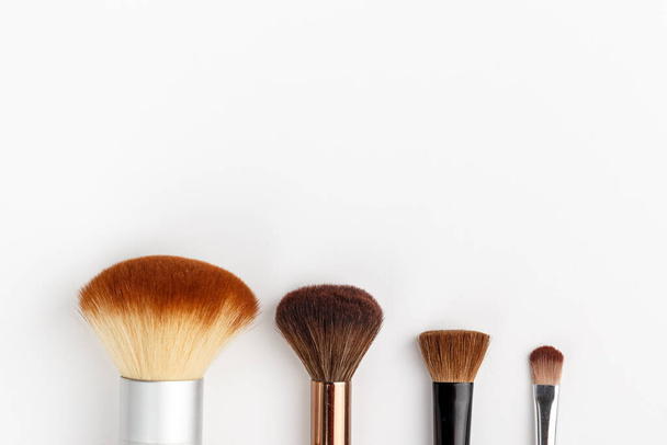 Makeup brushes of different sizes on a white background - Photo, Image