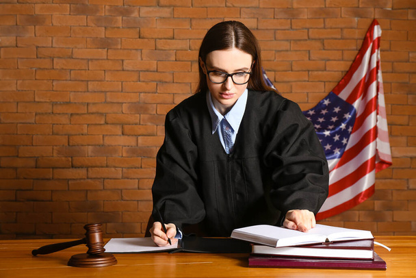 Female judge at table in courtroom - Fotó, kép