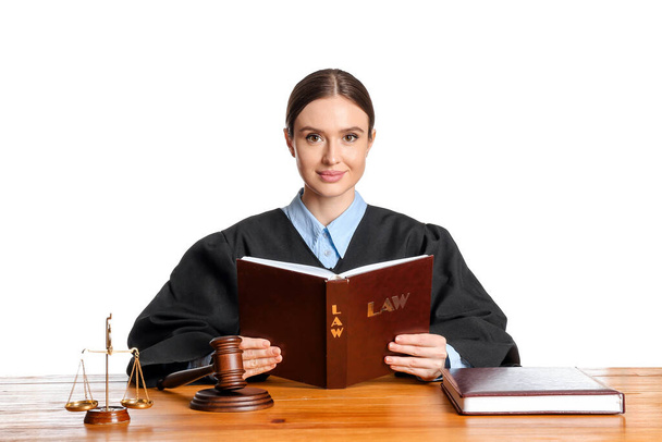 Női bíró könyv asztalnál fehér háttér - Fotó, kép