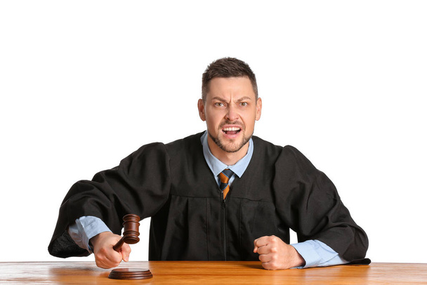 Angry male judge at table on white background - Foto, imagen