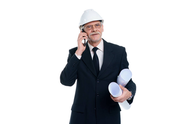 Older business man, civil engineer and designer wear a white safety helmet with project paper and phone isolated on white background. - Valokuva, kuva