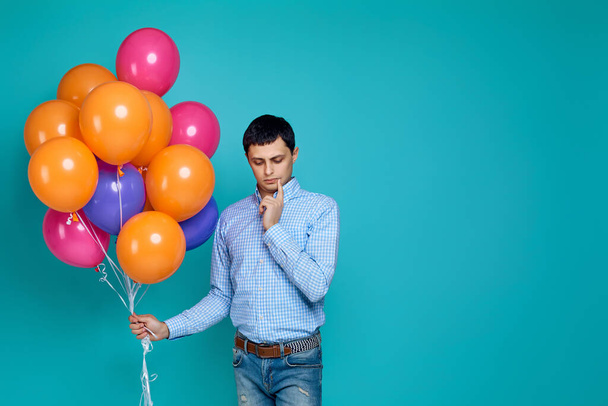 caucasian man in shirt with bright colorful balloons - Φωτογραφία, εικόνα