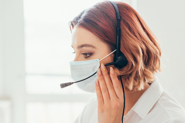 female freelancer in medical mask using headset to work from home on self isolation - Fotografie, Obrázek