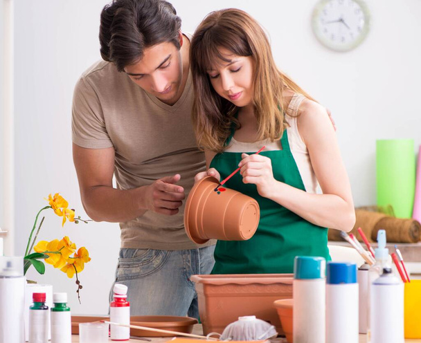 Couple decorating pots in workshop during class - Photo, Image
