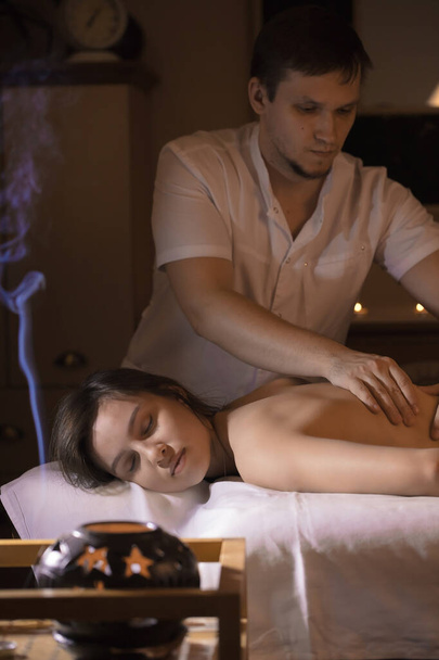 Beautiful girl in a massage parlor for back health treatments and aromatherapy - 写真・画像