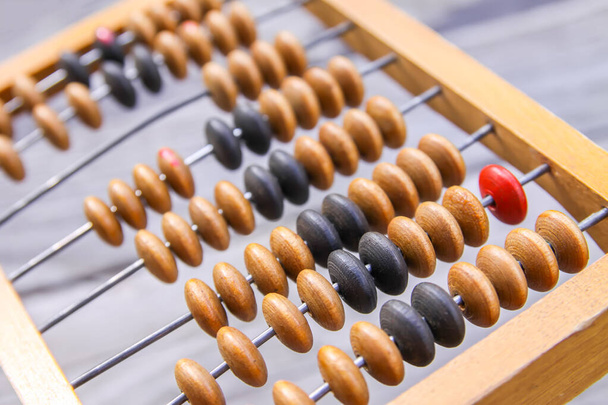 Vintage wooden abacus on old board surface. - Photo, Image