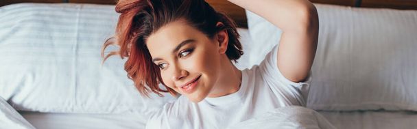 attractive happy girl relaxing in bed in morning during self isolation, horizontal concept - Photo, Image