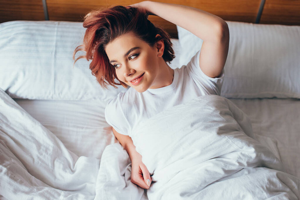 όμορφο κορίτσι χαλαρώνοντας στο κρεβάτι το πρωί κατά τη διάρκεια της αυτο-απομόνωσης - Φωτογραφία, εικόνα