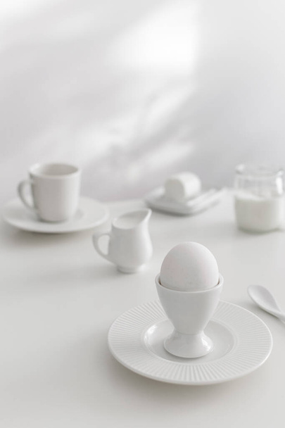 Minimal white breakfast, goat cheese, milk, plain yogurt, boiled egg, copy space - Foto, Bild