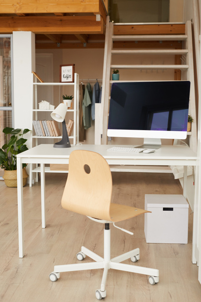 Vertical image of contemporary two level apartment interior with home office workplace in foreground, copy space - Photo, image