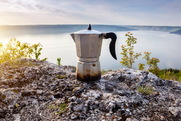 Metal coffee maker in nature. Making coffee. Camping in summer. - Photo, Image