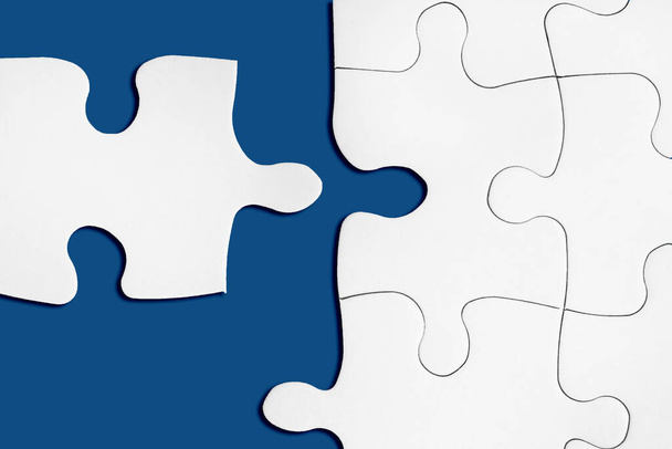 Matching puzzle piece on blue background. Successful decision, solution of problem. Business teamwork, partnership concept. Connecting or joining to company idea. Business success metaphor. Copy space - Photo, Image