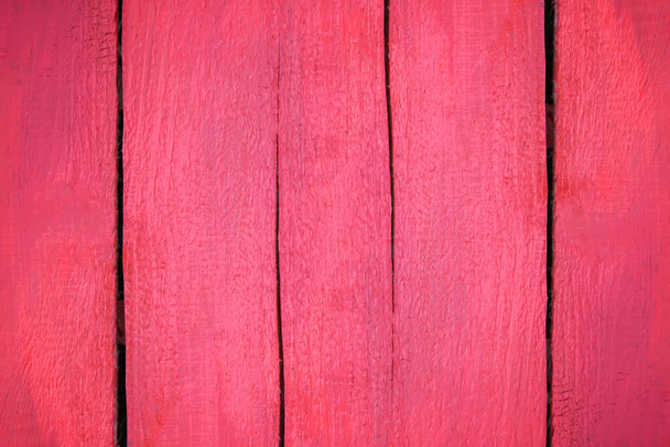 Oude rood geschilderde planken. Verouderde achtergrond. Grunge ruwe houttextuur. - Foto, afbeelding