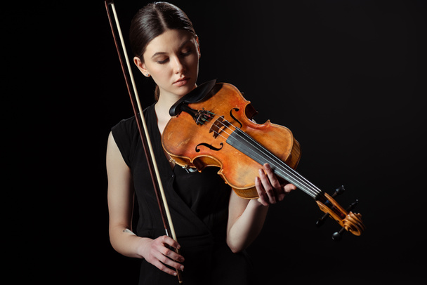 beautiful musician playing symphony on violin isolated on black - Photo, Image