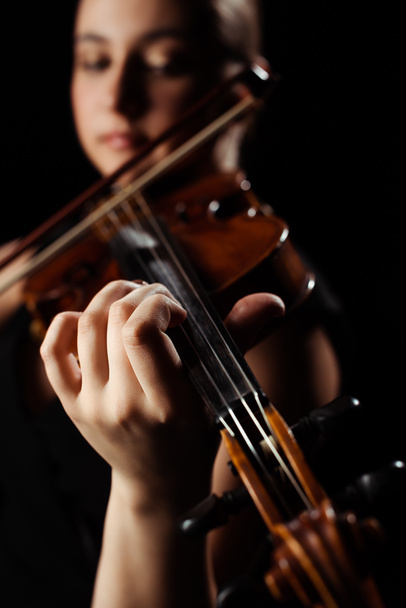 selective focus of female musician playing symphony on violin isolated on black - Photo, Image