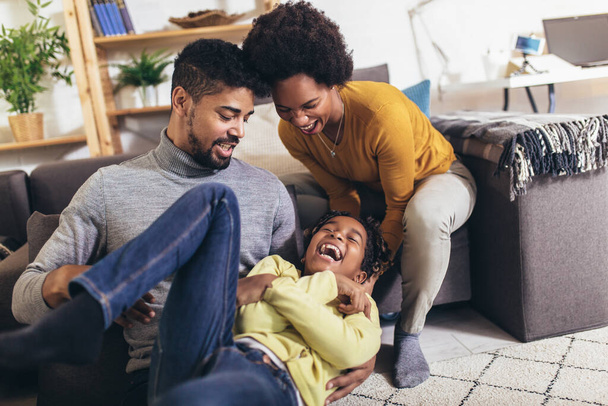 Happy african american family having fun at home. - Фото, изображение