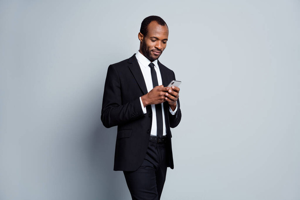 Portrait of his he nice attractive focused chic classy imposing guy employee banker holding in hands using device chatting planning meeting isolated over grey pastel color background - Φωτογραφία, εικόνα
