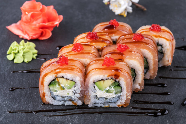 Japanisches Sushi-Essen. Maki-Brötchen mit Thunfisch, Lachs, Garnelen, Krabben und Avocado. - Foto, Bild