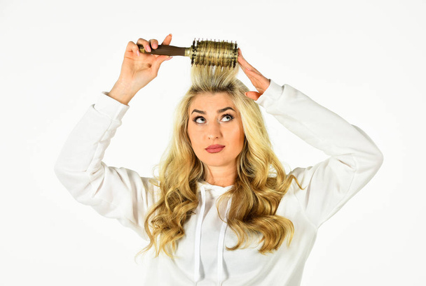 Pretty woman brushing hair isolated on white background. Long hair. Curling Your Hair Much Easier. Hot curling brush. Hair care. Hairdresser salon. Professional equipment. Beauty supplies shop - Photo, Image