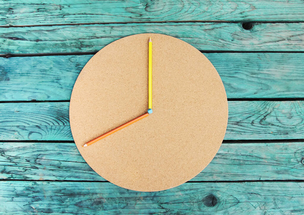 School supplies. Back to School design elements. Colored pencils and round cardboard on aged wooden table. - Foto, Imagen