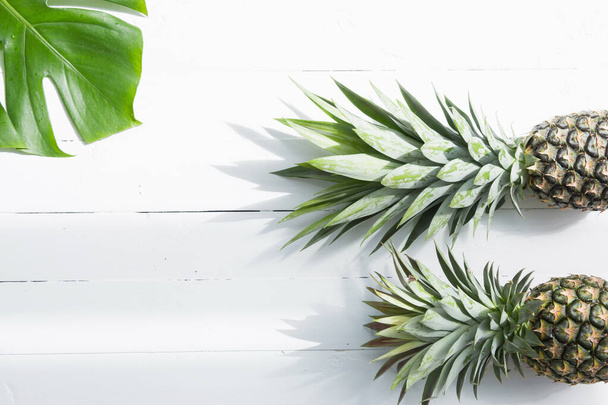 Pineapples with monstera leaves on white background. Copy space. - Foto, immagini