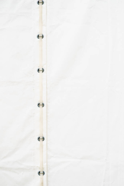 Close up of white party event tent details, hooks, stripes, cord strings. Detailed objects concept. - Fotó, kép