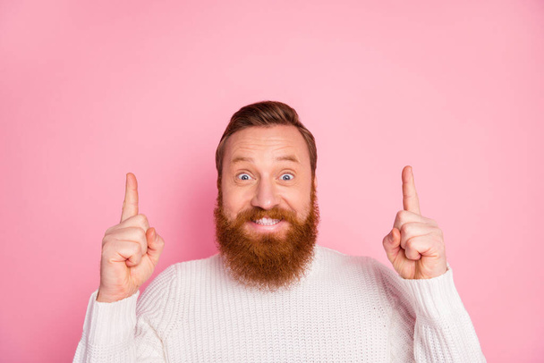 Close-up portrait of his he nice attractive amazed cheerful cheery red guy pointing two forefingers up copy space advice like follow subscribe isolated over pink pastel color background - Fotó, kép