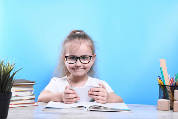 Back to school .Happy cute industrious child is sitting at a desk indoors. Kid is learning in class.quarantine.Kid is learning in home - Фото, зображення