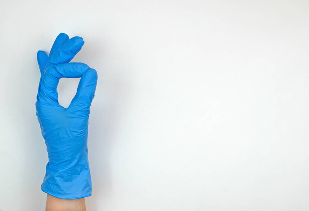 Hand in medical glove that simbol eveything is fine - 写真・画像
