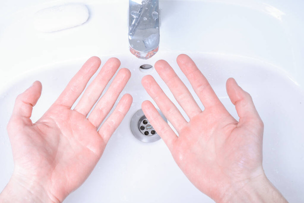 Washing hands in the sink rubbing with soap man for corona virus ,COVID-19 prevention, hygiene to stop spreading coronavirus. - Photo, Image