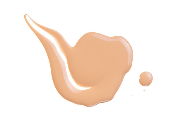 Makeup tone cream swatch isolated on white. Beige liquid foundation, concealer smear smudge drop. Cosmetic liquid foundation, concealer or moisturizer. Nude cosmetic BB cream sample. Macro, from above - Foto, Bild