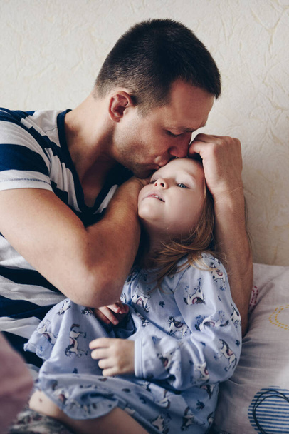 Dad hugs and kisses daughter. - Fotografie, Obrázek