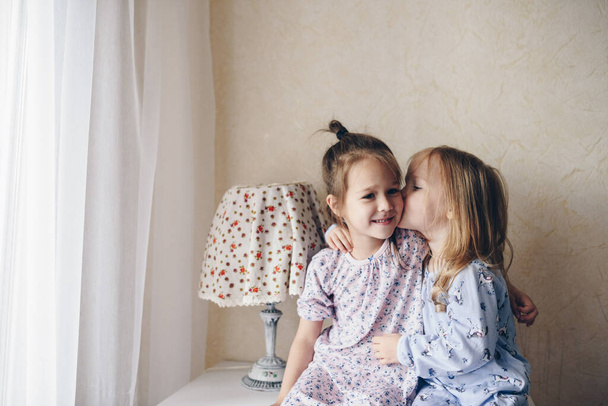 Two sisters embrace. Girls in family. - Photo, image