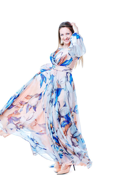 Girl in a long chic dress dancing on a white background - Foto, immagini