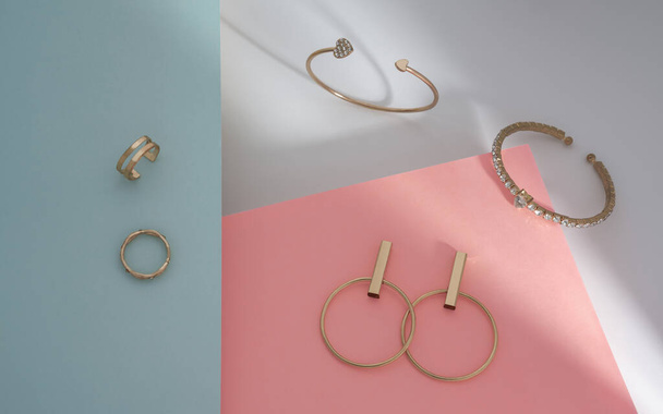 Top kilátás a lányok arany ékszerek gyűjtemény karkötők és fülbevalók pár és gyűrűk papír alapon - Fotó, kép
