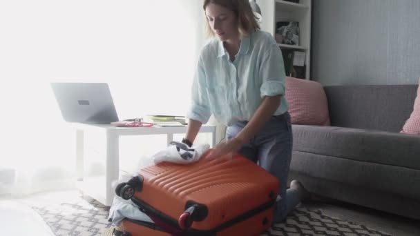 Travel woman packing suitcase getting ready for road trip, preparing luggage for vacation - Filmagem, Vídeo