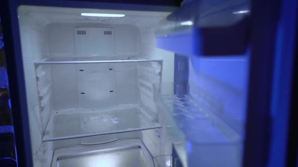 Empty fridge. A fired man suffers from depression and insomnia. A crisis. Unemployed looking for food in the refrigerator. Leftovers. Lack of money due to the financial crisis. Bachelor's fridge.  - Footage, Video