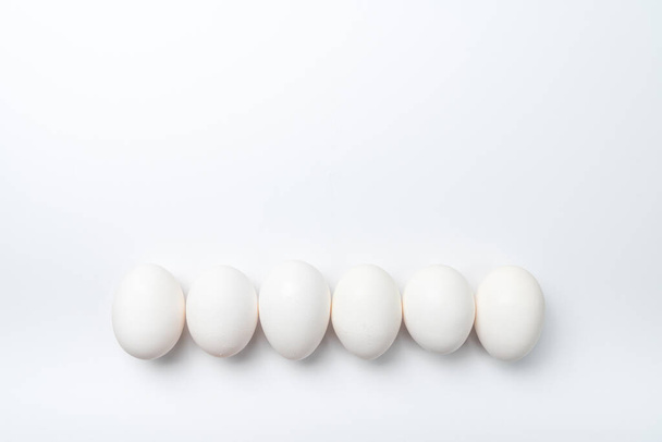 Six white chicken eggs in a row - Φωτογραφία, εικόνα