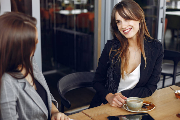Two businesswomen working in a cafe - Photo, image