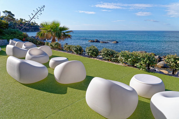 White chairs by the Mediterranean sea in a sunny day - Holiday, Travel Destination - Arbatax, Sardinia, Italy - 18th of May 2019 - Photo, Image