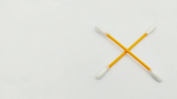A pair of ear swabs or cotton ear sticks on the light background. Ear care concept for Hygiene. Isolated. - Photo, Image