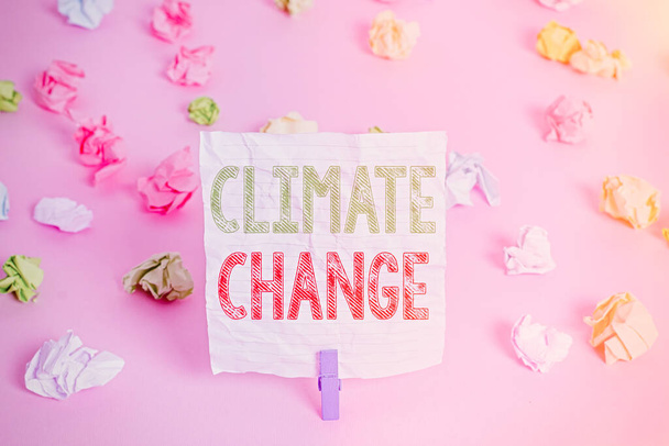 Text sign showing Climate Change. Conceptual photo Increase in global average temperature Weather transformation Colored crumpled papers empty reminder pink floor background clothespin. - Photo, Image