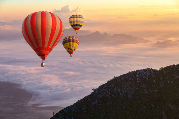 Colorful hot-air balloons flying over the Doi Luang Chiang Dao with sunrise and morning mist at Chiang mai, Thailand. - Photo, Image