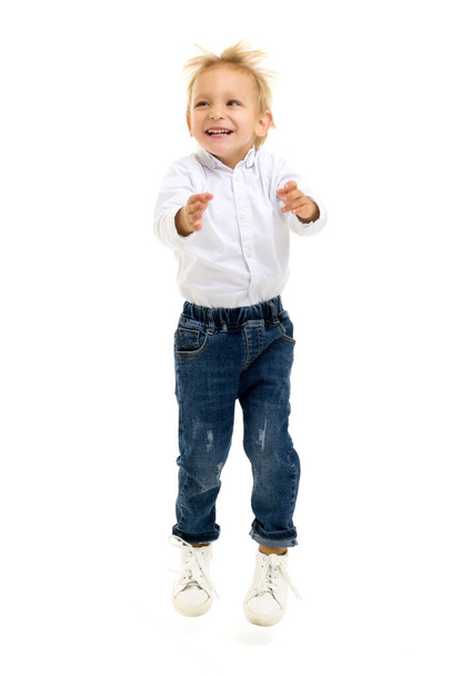 Little boy jumping.The concept of a happy childhood, sports and - Фото, изображение