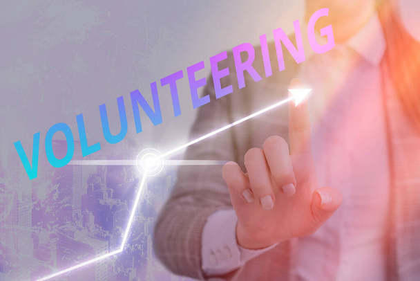 Textschild mit der Aufschrift "Volunteering". Konzeptfoto Bereitstellen von Dienstleistungen ohne finanziellen Gewinn Bereitwillig verpflichten. - Foto, Bild
