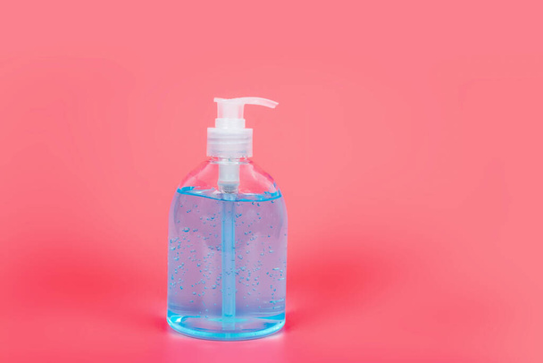 Alcoholgel Sanitizer handgel reinigers voor anti Bacteriën en virus op roze achtergrond, Mensen die alcohol gel gebruiken om handen te wassen om Coronavirus te voorkomen (COVID-19) - Foto, afbeelding
